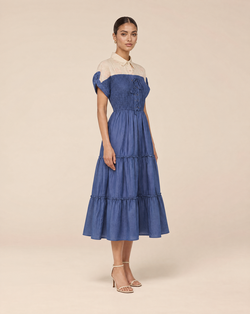 An elegant dress with embroidered floral details and smocking