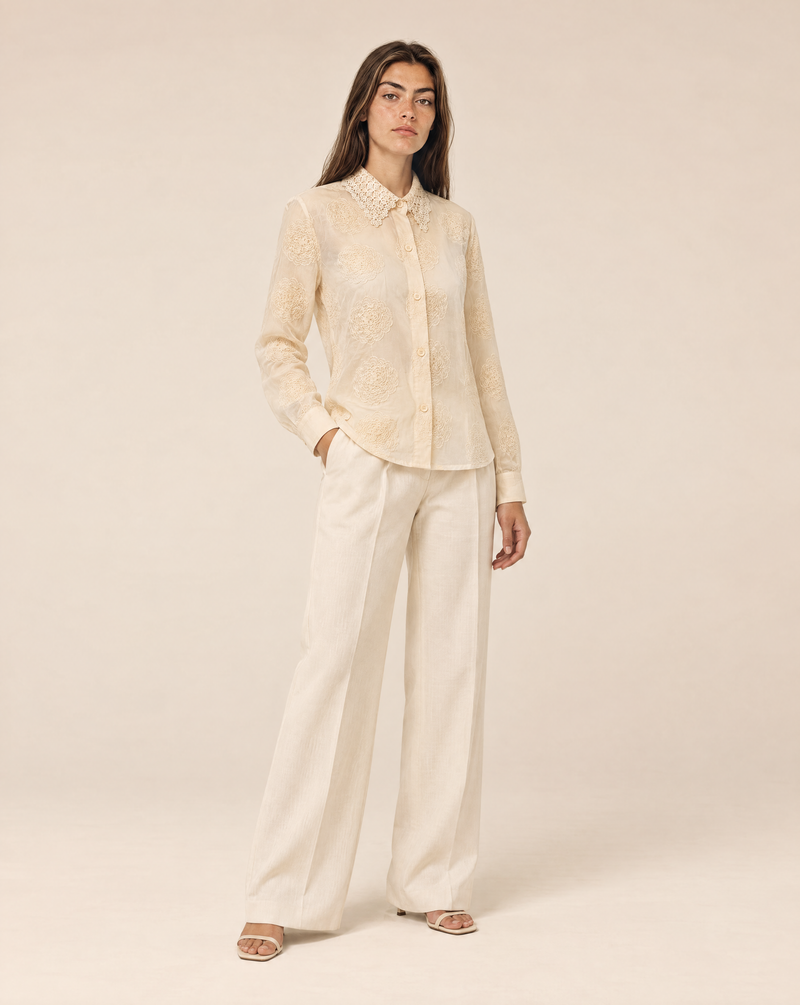 Embroidered women's shirt with raised flowers and a lace collar